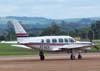 Piper/Neiva EMB-821 Caraj, PT-VEV, da Vera Cruz Txi Areo, taxiando no ptio da aviao geral. (29/12/2006)